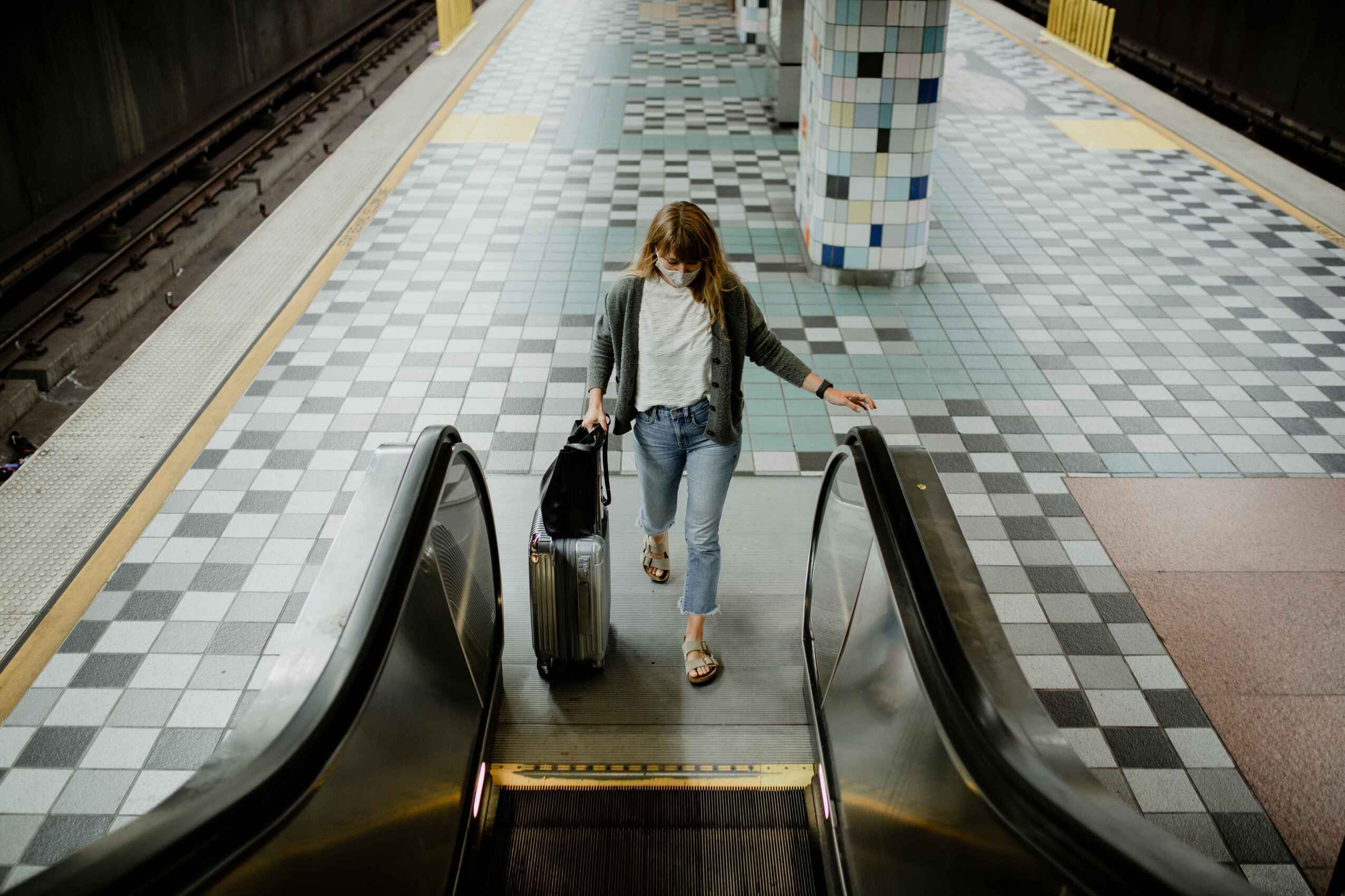 woman with a suitcase on an esca