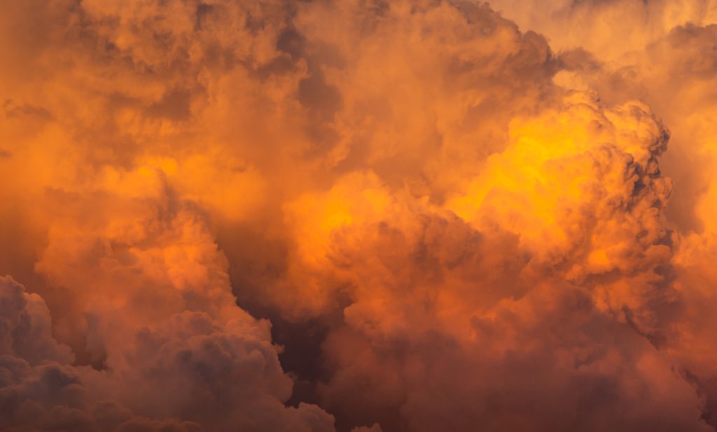Dramatic orange sky and clouds abstract background. Top view of